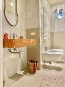 a bathroom with a sink and a toilet at FUTURA ROOM&RELAX in Termoli