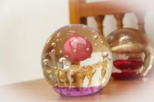 a glass ball with a dog on a table at Villa il Poderino in Marina di Campo