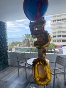 a balloon on top of a table on a balcony at Ocean Manor Tiki Sunset Retreat in Fort Lauderdale