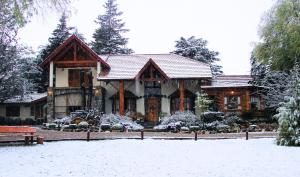 a house with snow on the ground in front of it at Blumenau Relax & Holidays in Villa General Belgrano