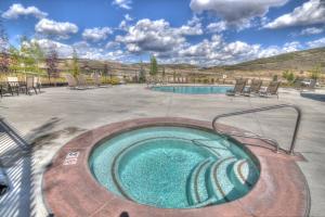 a hot tub in a patio with a pool at Retreat at Jordanelle 13282 by Moose Management in Park City