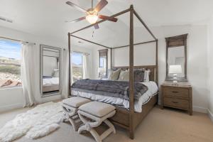 a bedroom with a canopy bed and a window at Retreat at Jordanelle 13282 by Moose Management in Park City