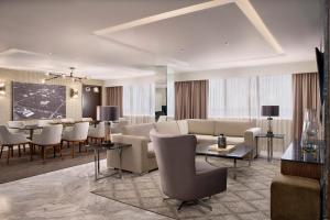 a living room with a couch and a dining room at Hyatt Regency Merida in M&eacute;rida