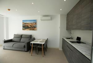 a kitchen with a couch and a table in a room at Apartahotel Puerto Blue in Puerto de Mazarrón