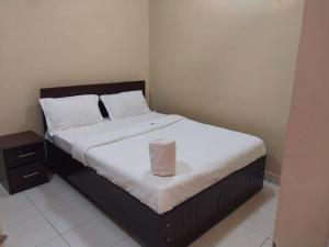 a bedroom with a bed with a roll on it at Tulba Hotel and Residences in Juba +5 photos