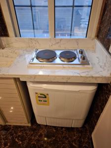 a kitchen counter with a stove top on top at بلند للشقق المخدومة اقتصادي in Dammam +32 photos
