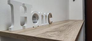 a wooden table with a sign that says love at Maison du Port in Civitavecchia