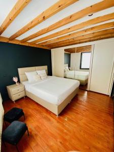 De Smet في بيفيرن: غرفة نوم بسرير ابيض كبير وارضيات خشبية