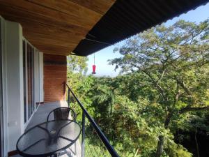 a balcony with a view of the trees at Casa Pistacho in Santa Marta