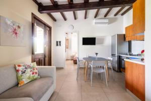 a living room with a couch and a table at Fiore di Vendicari B&B - Sicilian Charme, Lemon Grove and Sea in Noto