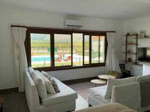a living room with a couch and a large window at El loft mas lindo de Cafayate! in Cafayate