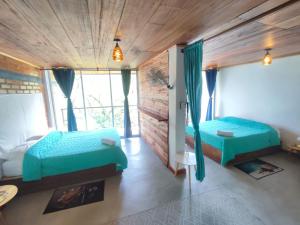 a bedroom with two beds and a fireplace at Casa Pistacho in Santa Marta