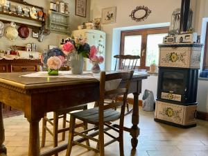 a kitchen with a table with flowers and a stove at La Locanda Del Tevere Slow tourism near Rome in Fiano Romano
