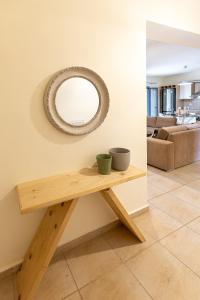 a table with two cups on top of it in a living room at FoRest & sea view apartment in Argostoli