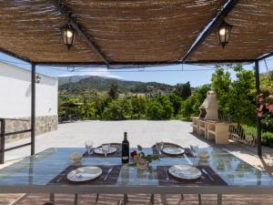 a table with a bottle of wine on a patio at Casa huerta maria in Chite