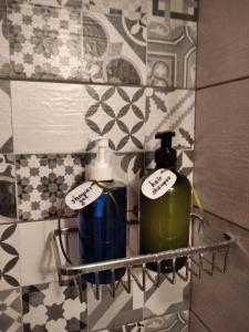 a bathroom with two soap bottles on a wall at ISLAND VIEW BEACH APARTMENT in Néa Péramos