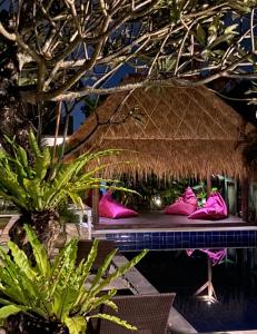 aikiikiiki room with pink shoes sitting on a bench at The Hideaway Canggu in Canggu