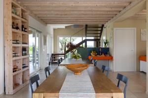a dining room with a large wooden table and chairs at Fiore di Vendicari B&B - Sicilian Charme, Lemon Grove and Sea in Noto