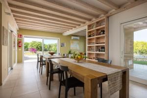 a large dining room with a long table and chairs at Fiore di Vendicari B&B - Sicilian Charme, Lemon Grove and Sea in Noto