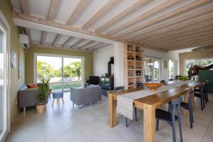 a dining room with a wooden table and chairs at Fiore di Vendicari B&B - Sicilian Charme, Lemon Grove and Sea in Noto