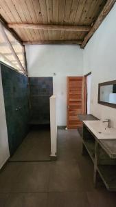 a bathroom with a sink and a mirror at Casa Kiwi Jungle Lodge in San Francisco