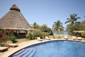 una piscina en un complejo con sillas y cenador en Hotel Playa Negra, en Paraíso
