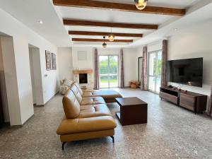 a living room with a couch and a flat screen tv at Resort Franko Spacious house with a pool in Obrov