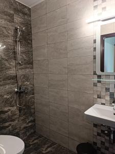 a bathroom with a shower and a sink at Coral Family Hotel in Chernomorets
