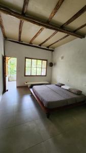 a bedroom with a large bed in a room at Casa Kiwi Jungle Lodge in San Francisco
