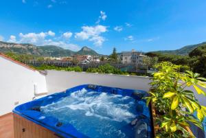 a hot tub on the roof of a house at YourHome - Jolly Pini Apartment in Sant'Agnello