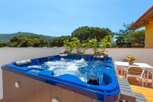 uma grande banheira de hidromassagem num pátio com uma mesa em YourHome - Jolly Pini Apartment em Sant'Agnello