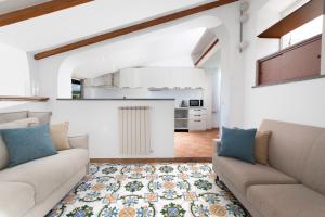 a living room with two couches and a rug at YourHome - Jolly Pini Apartment in Sant'Agnello