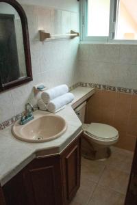 a bathroom with a sink and a toilet at Vista Caribe Playa in Playa del Carmen