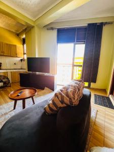 a living room with a couch and a table at Botique Inn in Kampala