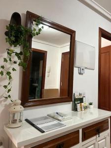 a bathroom counter with a mirror and a sink at Apartamento Casa Güelu in Arenas de Cabrales
