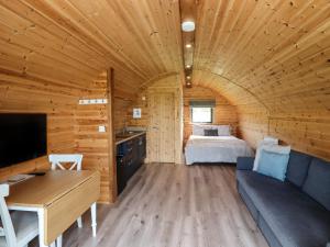 a room with a bed in a wooden cabin at Cleugh Lodge in Lockerbie