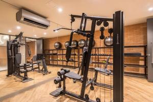 a gym with several exercise equipment in a room at Loft Moderno novo JPRE718 in Porto Alegre