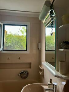 a bathroom with a sink and a window at Captain Christos Family Garden House in Lefkimmi +27 photos
