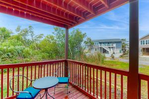 a patio with a table and chairs on a deck at Fenwick Island --- 20 W Maryland Avenue in Fenwick Island