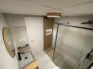 a bathroom with a shower and a glass shower stall at Boutique Apartment Torrevieja Centro in Torrevieja +9 photos