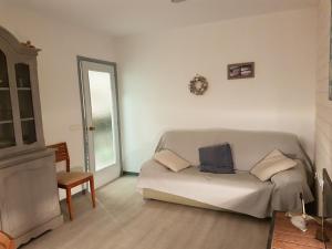 a white living room with a couch and a window at La Terrasse du Leo, Benicarló in Benicarló