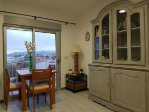a dining room with a table and a hutch at La Terrasse du Leo, Benicarló in Benicarló