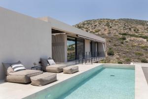 a house on a hill with a swimming pool at Apia Villas in Nafplio