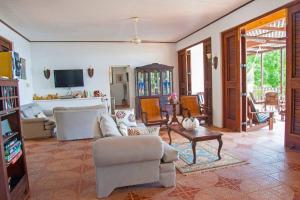 a living room with a couch and a table at Bliss By The Sea - Beach Front Villa with Private Pool in Treasure Beach