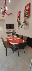 a dining room with a red table and chairs at Palace Apartment in Budapest