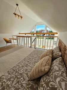a bedroom with a bed and a balcony at Binibona Barn Haven Rydzewo in Rydzewo