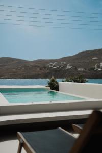 a view of a swimming pool seen through a window at Mykonos Pantheon in Kalo Livadi