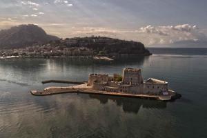 an island in the middle of a body of water at Mermaid apartment Nafplio in Nafplio