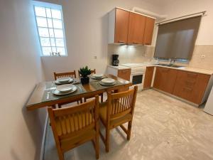 a kitchen with a table and two chairs and a table and a kitchen with at Mermaid apartment Nafplio in Nafplio