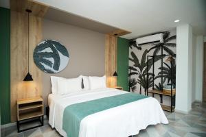 a bedroom with a large white bed and green walls at Hotel Arbóreo Doradal in Doradal +216 photos